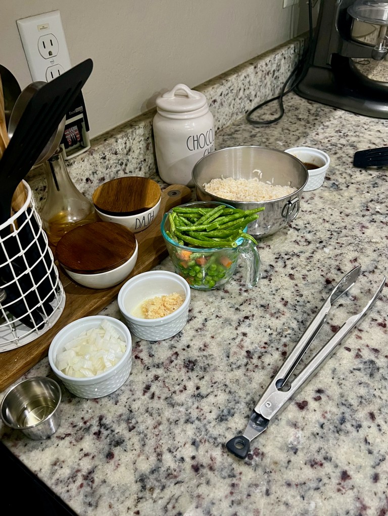 A row of ingredients is neatly lined up in the order of their use. 