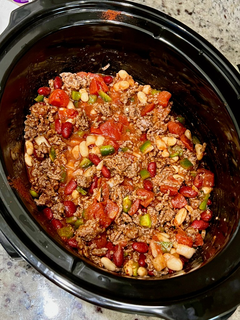 A slow cooker full of chili. 